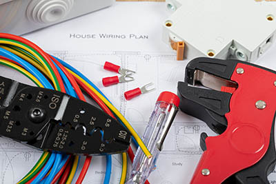 Electrical tools and wires on a house wiring plan