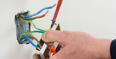 Electrician repairing light switch