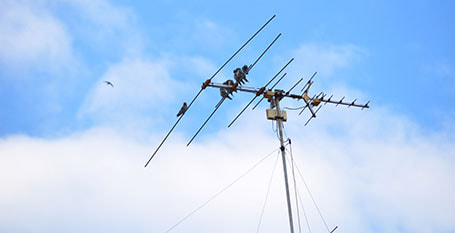 TV antenna with a blue sky background